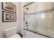Clean bathroom design with tile shower, new fixtures, and decorative artwork create a modern experience at 5085 Knobcone Dr, Castle Rock, CO 80108