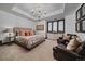 Relaxing bedroom with a chandelier, sitting area, and natural light at 5085 Knobcone Dr, Castle Rock, CO 80108