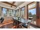 A sun-drenched dining area with hardwood floors, a chandelier, and a view to the outdoors at 5085 Knobcone Dr, Castle Rock, CO 80108