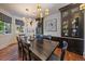 The dining room features hardwood floors and decor with a modern chandelier and ample seating at 5085 Knobcone Dr, Castle Rock, CO 80108