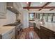 This gourmet kitchen features wooden floors, a farmhouse sink, and an expansive countertop space at 5085 Knobcone Dr, Castle Rock, CO 80108
