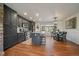 Stylish kitchen with dark cabinets, an island, and an adjacent dining area at 5085 Knobcone Dr, Castle Rock, CO 80108