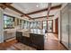 The gourmet kitchen includes wooden floors, a farmhouse sink, island seating, and natural light at 5085 Knobcone Dr, Castle Rock, CO 80108