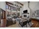 An expansive living room with exposed beams, a fireplace, and abundant natural light at 5085 Knobcone Dr, Castle Rock, CO 80108