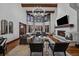 A grand living room with a fireplace, hardwood floors, and large windows at 5085 Knobcone Dr, Castle Rock, CO 80108