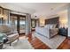Comfortable main bedroom with hardwood floors, sitting area, and access to the balcony at 5085 Knobcone Dr, Castle Rock, CO 80108