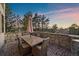 Charming outdoor patio with stone surround and sunset views makes for exceptional outdoor living at 5085 Knobcone Dr, Castle Rock, CO 80108