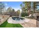Backyard pool with brick accents, lounge chairs, and tall pine trees at 5085 Knobcone Dr, Castle Rock, CO 80108
