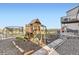 Backyard with a playground set, trampoline, stone patio, and gravel landscaping at 4746 River Highlands Loop, Elizabeth, CO 80107