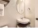 Powder room with modern sink, cabinet, and decor at 4746 River Highlands Loop, Elizabeth, CO 80107