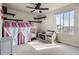 Bedroom features cat climbing shelves, carpet flooring, curtains, and a bright window at 4746 River Highlands Loop, Elizabeth, CO 80107