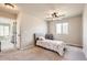Bright bedroom features neutral walls, carpet flooring, ceiling fan, and ample natural light from the window at 4746 River Highlands Loop, Elizabeth, CO 80107