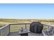 Enjoy the outdoors on this spacious deck with gray composite decking, a fire pit, and expansive rural views at 4746 River Highlands Loop, Elizabeth, CO 80107