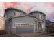 Two story home with an attached two car garage, vinyl siding, stone accents, and covered entryway at 4746 River Highlands Loop, Elizabeth, CO 80107