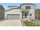 Charming two-story home with a gray exterior, landscaped front yard, and a two-car garage at 4746 River Highlands Loop, Elizabeth, CO 80107