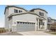 Charming two-story home with a gray exterior, stone accents, and a two-car garage at 4746 River Highlands Loop, Elizabeth, CO 80107
