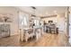 Open concept dining and kitchen area with granite counters, stainless appliances, and wood floors at 4746 River Highlands Loop, Elizabeth, CO 80107