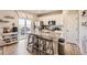 Bright kitchen featuring a granite island with seating and stainless steel appliances at 4746 River Highlands Loop, Elizabeth, CO 80107