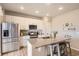 Bright kitchen featuring a granite island with seating and stainless steel appliances at 4746 River Highlands Loop, Elizabeth, CO 80107