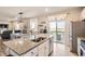 Bright kitchen with white cabinets, granite counters, stainless steel appliances, and an open floorplan at 4746 River Highlands Loop, Elizabeth, CO 80107