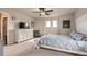 Cozy main bedroom featuring a large bed, ceiling fan, and natural light at 4746 River Highlands Loop, Elizabeth, CO 80107