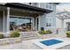 Outdoor patio with gas firepit, stone retaining wall, and covered outdoor living space at 27608 E Ottawa Ave, Aurora, CO 80016
