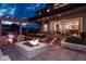 Backyard with outdoor grill station, covered patio, and fire pit with seating area at 27608 E Ottawa Ave, Aurora, CO 80016