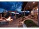 Backyard with a stone fire pit, outdoor kitchen, pergola, and covered back porch at 27608 E Ottawa Ave, Aurora, CO 80016