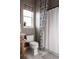 Cozy bathroom with neutral tones, featuring a toilet, vanity, and shower with stylish curtain at 27608 E Ottawa Ave, Aurora, CO 80016