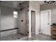 Clean glass enclosed shower with bench seating and herringbone tile feature wall in the modern bathroom at 27608 E Ottawa Ave, Aurora, CO 80016
