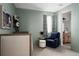 Neutral-toned bedroom with soft carpet, sitting chair and ensuite bathroom access at 27608 E Ottawa Ave, Aurora, CO 80016