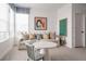 Bright bonus room featuring a sofa and table with chairs, perfect for recreation and relaxation at 27608 E Ottawa Ave, Aurora, CO 80016