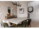 Bright dining room with decorative wallpaper, stylish sideboard, and modern art at 27608 E Ottawa Ave, Aurora, CO 80016