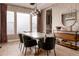 Elegant dining room with decorative wallpaper, modern lighting, and stylish sideboard at 27608 E Ottawa Ave, Aurora, CO 80016