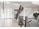 Bright foyer featuring wood floors, staircase, and modern front door at 27608 E Ottawa Ave, Aurora, CO 80016