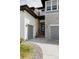 Home featuring a two-car garage, stone and siding accents, and a modern front door at 27608 E Ottawa Ave, Aurora, CO 80016