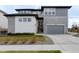 Two-story home with a manicured lawn and stone and siding accents at 27608 E Ottawa Ave, Aurora, CO 80016