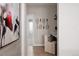 Hallway with light hardwood floors, modern art and work station at 27608 E Ottawa Ave, Aurora, CO 80016