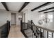 Upstairs hallway with wood floors, exposed beams, and modern light fixtures at 27608 E Ottawa Ave, Aurora, CO 80016