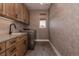 Efficient laundry room with ample cabinet space, modern appliances, and a functional layout at 27608 E Ottawa Ave, Aurora, CO 80016