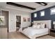 Spacious primary bedroom featuring modern decor, ensuite access, and ample lighting at 27608 E Ottawa Ave, Aurora, CO 80016