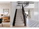 Carpeted staircase with dark wood banister, leading to an open living area at 27608 E Ottawa Ave, Aurora, CO 80016