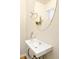 Powder room featuring a modern sink, chrome faucet, and decoratively framed mirror at 320 Marshall Mews, Superior, CO 80027
