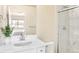 Modern bathroom featuring a quartz vanity, a decorative mirror, and a marble tile shower at 320 Marshall Mews, Superior, CO 80027