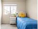 Charming bedroom with a blue quilt, a white nightstand, and a sun-shaped throw pillow at 320 Marshall Mews, Superior, CO 80027
