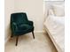 Stylish bedroom with a comfortable green chair, a neutral carpet, and a rustic style bed at 320 Marshall Mews, Superior, CO 80027