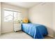 Inviting bedroom features a blue quilt, a white nightstand, and a decorative flower pillow at 320 Marshall Mews, Superior, CO 80027