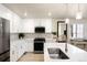 Bright kitchen with stainless appliances, white cabinets, light countertops, sink, island, and mirror at 320 Marshall Mews, Superior, CO 80027