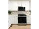 Bright kitchen featuring stainless steel appliances, a tile backsplash, and crisp white cabinetry at 320 Marshall Mews, Superior, CO 80027