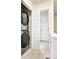 Efficient laundry room featuring a stacked washer and dryer and stylish white paneled doors at 320 Marshall Mews, Superior, CO 80027